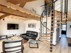 een woonkamer met een wenteltrap in een loft bij Appartement d'exception, terrasse vue Pic du Midi in Bagnères-de-Bigorre