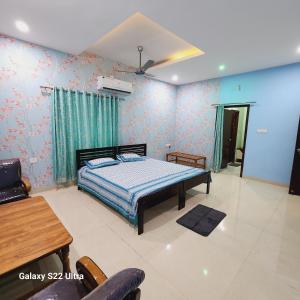1 dormitorio con 1 cama, mesa y sillas en Om Villa, en Bhopal