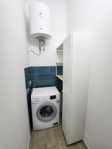 a washer and dryer in a small bathroom at L'Attico Blu - Affitti Brevi Italia in Valledoria +8 photos