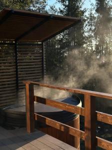 a hot tub on a deck with a gazebo at The Sunset Cabin будиночок з Чаном in Zhuraky