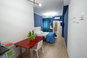 ein Schlafzimmer mit einem Bett und einem Tisch mit einem roten sidx. in der Unterkunft PALAZZO ENNIO in Bari