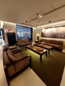 a large living room with couches and a table at Regal Pacific Puerto Madero in Buenos Aires