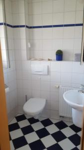 a bathroom with a toilet and a sink at Haus Nordsee in Emden
