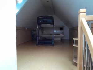 an attic room with a staircase and a treadmill at Haus Nordsee in Emden