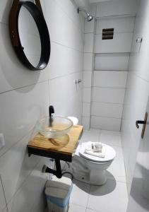a bathroom with a bowl sink and a toilet at BOB Suítes in Porto De Galinhas
