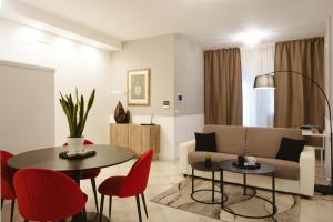 a living room with a couch and a table and chairs at ALBERGO DIFFUSO Dimora Rossi Charme B&B in Turi
