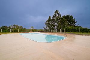 una piscina vacía en medio de un campo en Terra Sertaneja - Chalé Evidências II, en Piedade