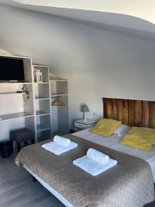 a bedroom with two beds and a flat screen tv at YEY Baleal in Peniche