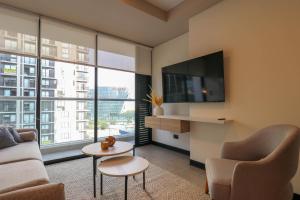 a living room with a couch and a tv at Navarrete Residence in Premium San Isidro by Wynwood House in Lima
