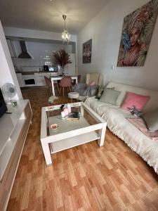 a living room with a couch and a coffee table at Apartamento Brisa junto al mar in Roquetas de Mar +6 photos
