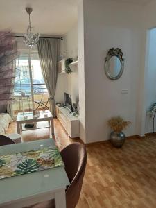 a living room with a couch and a table at Apartamento Brisa junto al mar in Roquetas de Mar