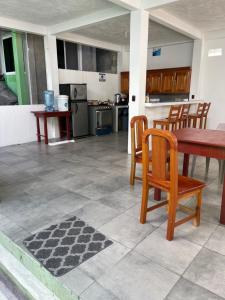 a kitchen and dining room with a table and chairs at Sun Breeze Hotel in El Remate