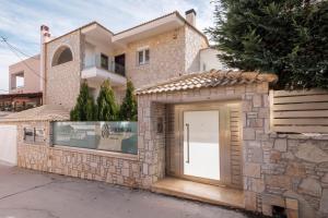 a stone house with a door in front of it at Shemesh Residence in Nafplio