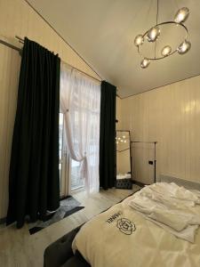 a bedroom with a bed and a large window at Ехо Тростяну in Slavske