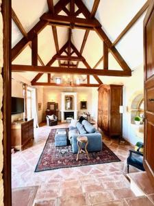 a living room with a blue couch and a rug at The Lion House in Mouzens