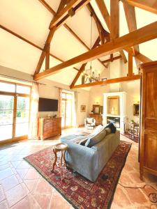 a large living room with a couch and a rug at The Lion House in Mouzens +88 photos