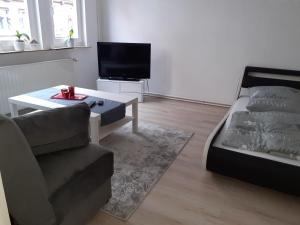 a living room with a couch and a coffee table at Fachwerk-Appartement mit Charme in Bad Sooden-Allendorf