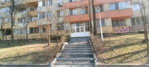 a building with stairs in front of a building with graffiti at Confort Studio 1 City Center in Bucharest