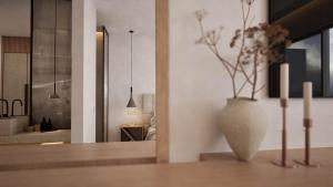 a living room with a vase with flowers in it at The Wave in Sidari