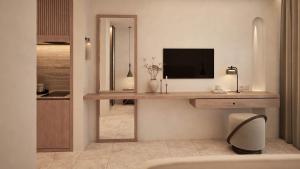 a room with a desk with a television and a mirror at The Wave in Sidari