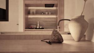 a kitchen with two sculptures sitting on a wooden floor at The Wave in Sidari