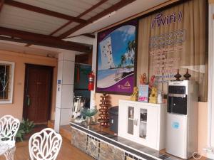 a restaurant with a large screen on the side of a building at PF Resort in Nong Prue