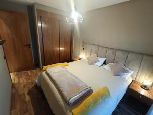 a bedroom with a large white bed with two pillows at Studio Cosy Haut Standing in Casablanca