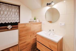 a bathroom with a sink and a mirror at Chata Liptov, Domček v záhradách in Liptovská Osada