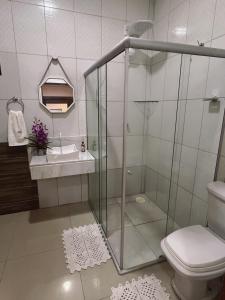 a bathroom with a shower and a toilet and a sink at Casa de Praia em Lagoa do Pau Coruripe in Coruripe
