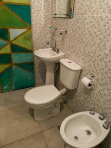 a bathroom with a toilet and a sink at Casa Nuestra Hostal in Salta