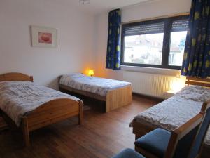 a room with two beds and a window at Ferienwohnung Am Homburg Nr 3 in Saarbrücken