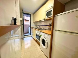 a kitchen with a refrigerator and a washer and dryer at Apartamentos Dos Torres Gandalf - Excelente ubicación centrica con garaje incluido in Zaragoza