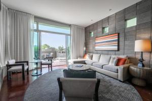 a living room with a couch and a table at Sanctuary Camelback Mountain Resort and Spa in Scottsdale