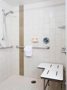 a bathroom with a shower with a bench in it at Hyatt Place San Antonio Northwest/Medical Center in San Antonio
