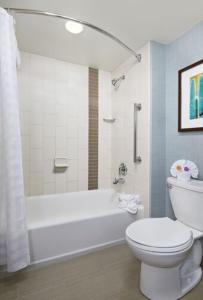 a bathroom with a white tub and a toilet and a sink at Hyatt Place San Antonio Northwest/Medical Center in San Antonio