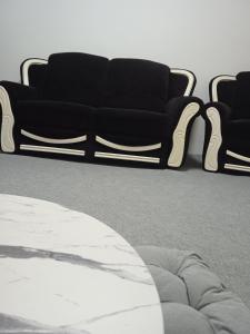 a black couch sitting in a living room at Hostel Center Luxury in Sarajevo