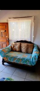 a couch sitting in a room with a window at Fullmoon Guasacate House in Popoyo