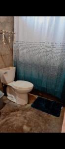 a bathroom with a toilet and a shower at Fullmoon Guasacate House in Popoyo