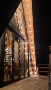een gebouw met een glazen deur met verlichting bij The Sunset Cabin будиночок з Чаном in Zhuraky