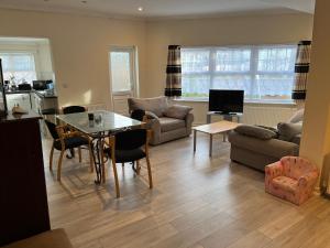 a living room with a table and a dining room at Apartments close Spurs stadion station 1 minute away in London