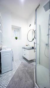 a white bathroom with a sink and a shower at Spacious Apartment with 3 meter ceilings, Powiśle, The Old Town in Warsaw +34 photos