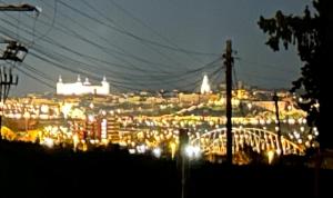 a view of a city at night with lights at Sueña Toledo in Toledo