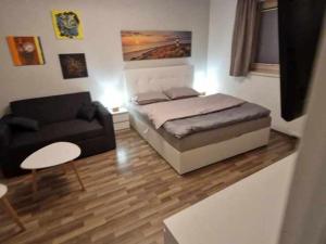 a living room with a bed and a couch at Studio Bizjak in Vrhnika