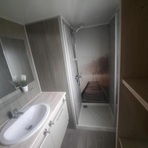 a bathroom with a sink and a view of a pier at Seacottage Blankenberge - Wenduine in De Haan