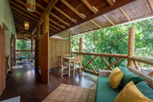 a living room with a couch and a table at Pousada Cajueiro Trancoso in Trancoso