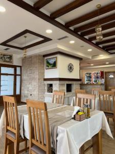 a dining room with a white table and chairs at Hotel Han Jelica in Konjic