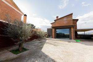 a brick building with a large window on the side of it at Chalet Els pins, Banyoles in Banyoles