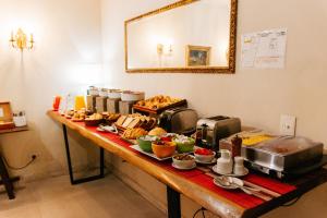 a buffet line with food on a table at BENS L'Hôtel Palermo in Buenos Aires