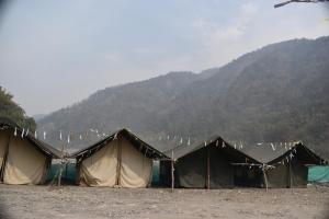 a row of tents in front of a mountain at Wild Leaf Camps in Rishīkesh