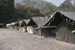 a row of tents lined up in a field at Wild Leaf Camps in Rishīkesh